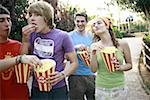 Teenagers hanging out eating popcorn