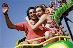 Teenage couple on amusement park ride