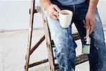 Painter Sitting on Ladder with Coffee