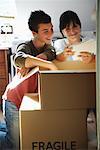 Woman and Boy Looking through Box of Photographs