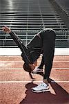 Athlete Stretching on Track