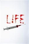 Red written word LIFE and a syringe