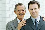 Two businessmen smiling at camera, portrait