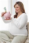 Pregnant Woman Putting Money in Piggy Bank