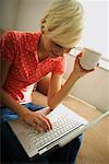 Woman Using Computer, Drinking Coffee