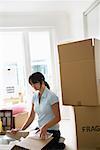 Woman with Boxes in Home