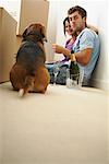 Couple Eating Pizza in New Home with Dog