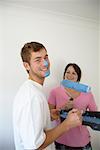 Couple with Wall Paint on Faces