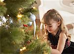 Girl Sitting by Christmas Tree