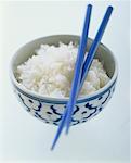 Cooked rice in Asian bowl with chopsticks