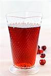 Cranberry juice in glass, fresh cranberries