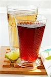 Apple juice and cranberry juice, wedge of lime