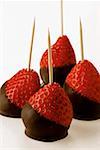 Chocolate-coated strawberries on toothpicks
