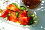 Tomatoes with fresh basil in olive oil