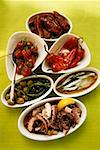 Assorted antipasti: pickled vegetables, fish, octopus