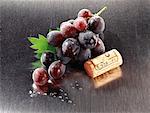 Wine cork and red grapes