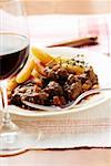 Venison ragout with potato noodles & thyme, red wine glass