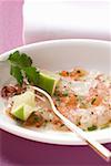 Carpaccio of raw shrimps with limes and coriander leaves