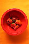 Habanero chili peppers in red bowl