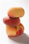 Three peaches (old variety), in a pile