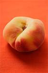 Peach (old variety) on orange background