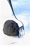 Black truffle with fork