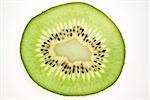 Slice of kiwi fruit, backlit