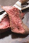 Two slices of beef steak beside knife