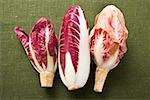 Three different types of radicchio on green background