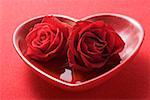 Red roses in heart-shaped bowl