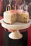 Femme qui dessert gâteau d'anniversaire avec soufflé les bougies