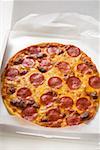 Whole salami and cheese pizza in pizza box