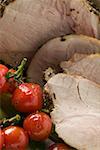 Roast pork with cherry tomatoes (close-up)
