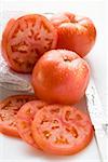 Tomatoes, whole, halved and slices, with drops of water