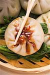 Filled yeast dumplings with hoisin sauce on pak choi (Thailand)