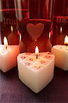 Burning heart-shaped candles for Valentine's Day