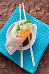 Vietnamese rice paper rolls with chopsticks and dip