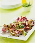 Lamb and onion kebabs with lime wedges