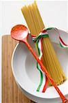 Spaghetti with Italian ribbon and cooking spoon