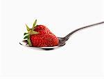 A strawberry on a spoon