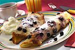 Two blueberry pancakes with cream