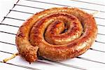 Coiled sausage on oven rack