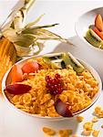 A bowl of cornflakes with fresh fruit