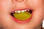 Child eating yellow wine gum