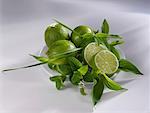 Limes and assorted herbs on a plate