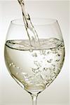 Pouring mineral water into a wine glass