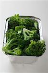 Steamed broccoli in an aluminium container