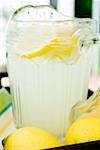 Lemonade in a glass jug with slices of lemon