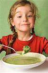 Girl eating vegetable soup