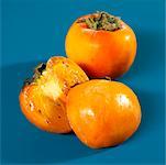 Whole and halved kaki persimmons